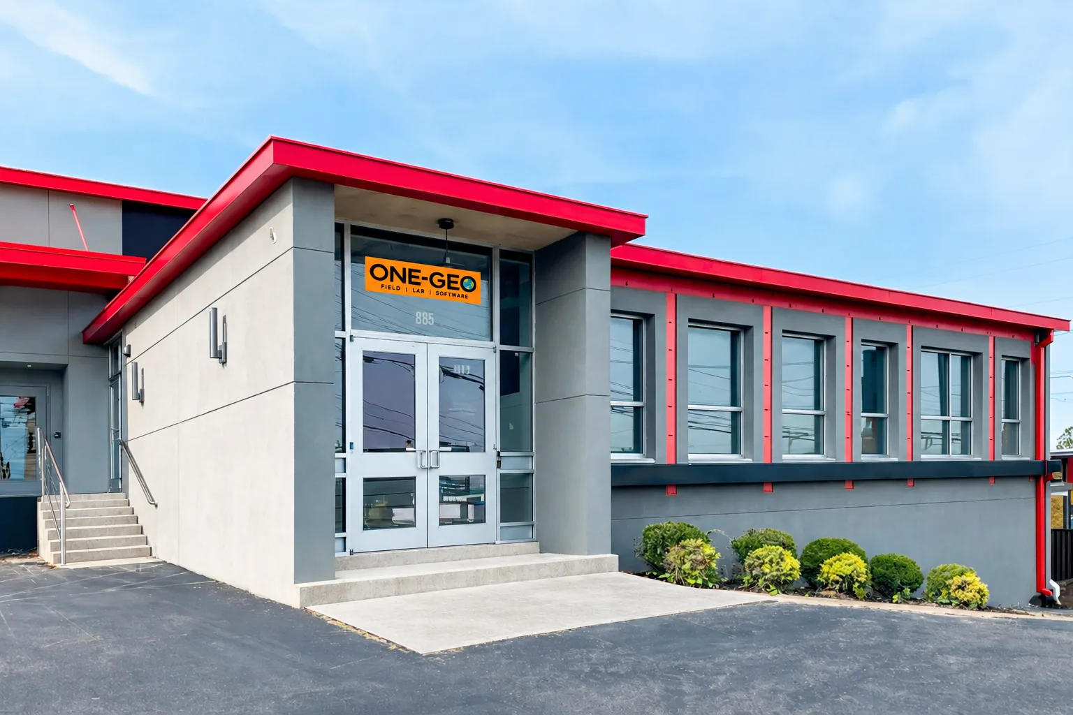 One Geo's headquarters in Nashville: a grey building with red trim and the One-Geo sign over the entrance